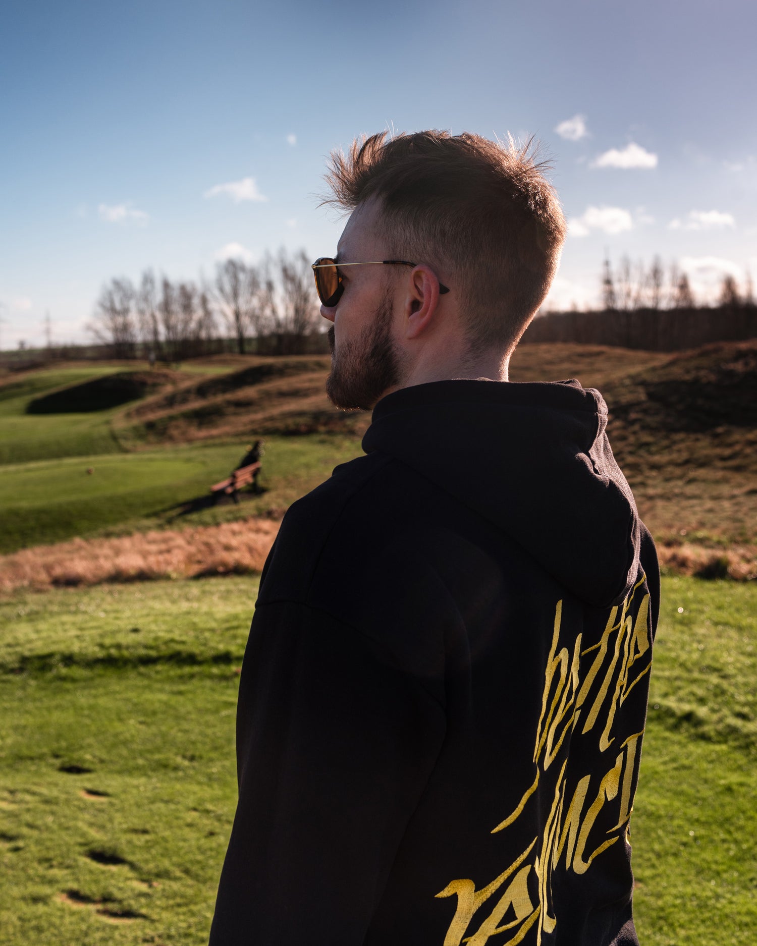 Co-Founder Sebastian wearing the Revolución Golf Hoodie from Paxariño on the Golf Course. 